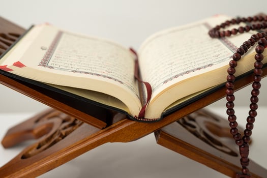 Open old Quran book on a table photo