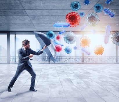 Businessman with umbrella covers himself from bacteria. Concept of solution to stop viruses contamination and pandemic photo