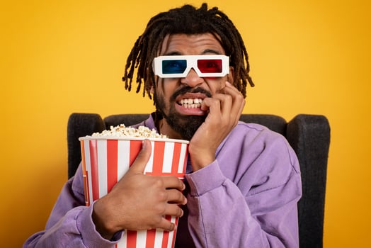 Boy has fun watching a film. Concept of entertainment and streaming tv. yellow background photo