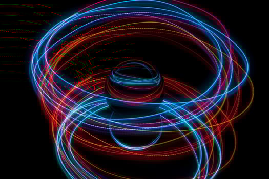 Abstract light painting circling around a glass ball photo