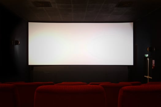 Empty movie theater with blank screen photo