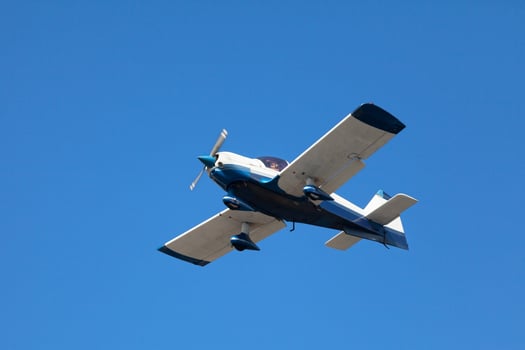 White and blue civil aircraft in mid air photo