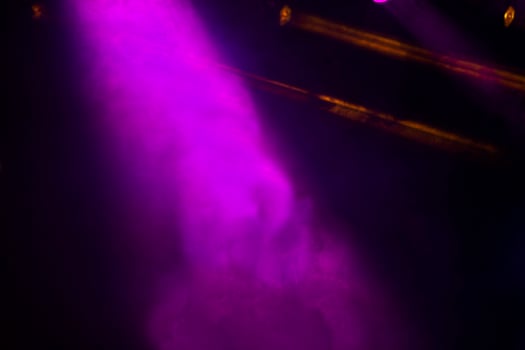 Background of the concert stage from purple smoke on a black background. photo