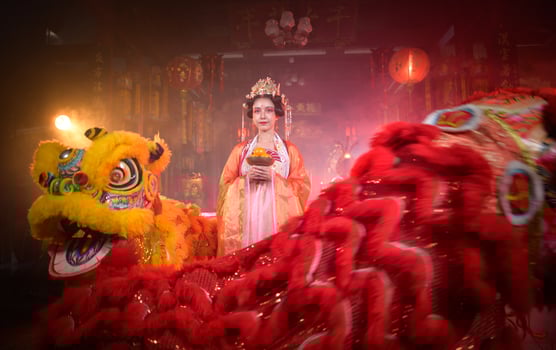Chinese woman with yellow and red lions It is considered to enhance the prosperity for oneself on the occasion of the Chinese New Year festival every year photo