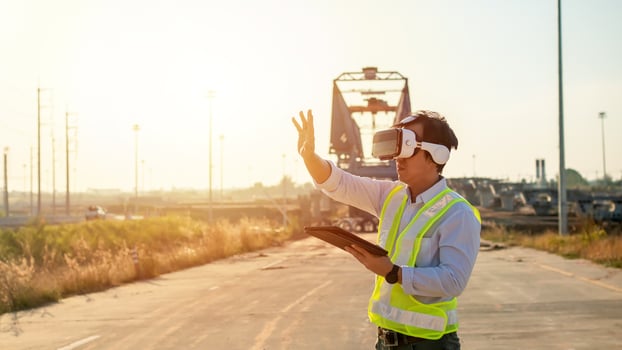 Asian engineer using virtual reality headset and tablet for inspecting and working at construction site photo