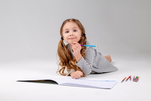 portrait of a little girl of Slavic appearance who does her homework. place for text photo