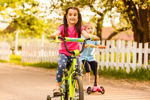 Smiling children posing with bikes in the park photo