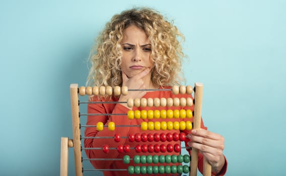 Girl with abacus is confused about the sum . cyan background photo