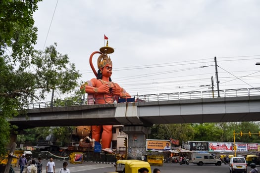 New Delhi, India - June 21, 2022 - Big statue of Lord Hanuman near the delhi metro bridge situated near Karol Bagh, Delhi, India, Lord Hanuman big statue touching sky photo