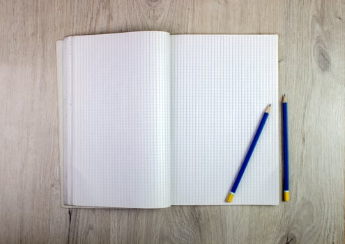 Notepad and pencil on wood table photo