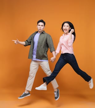 Young Asian couple standing on background photo