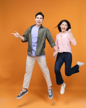 Young Asian couple standing on background photo