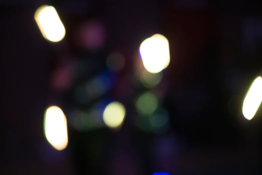 White bokeh spots on a dark background of a night city. photo