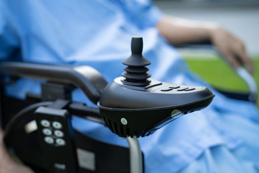 Asian senior woman patient on electric wheelchair with remote control at hospital, healthy strong medical concept. photo