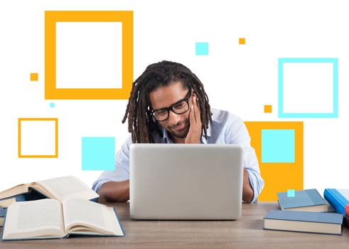 Student studies with his laptop with a desk full of books. Concept on online exam photo