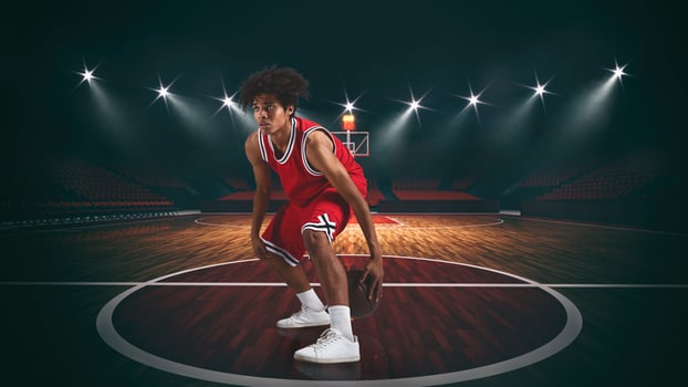 Young African American boy with basketball in the middle of the stadium photo