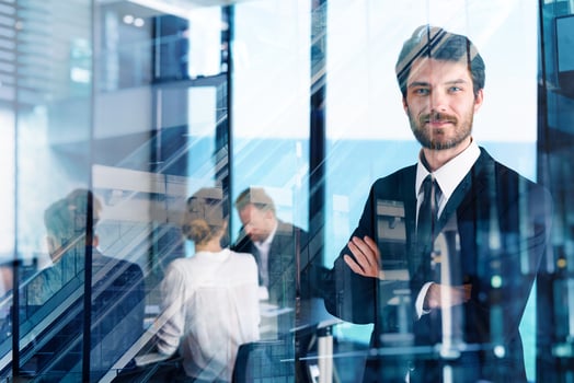 Confident businessman in office with his teamwork. Concept of cooperation photo