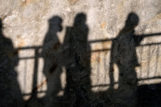 Shadow of a crowd of people on a cliff photo