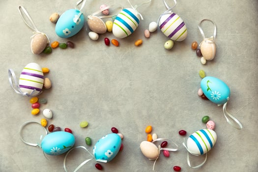 Happy Easter concept. Preparation for holiday. Easter eggs candy chocolate eggs and jellybean sweets on concrete stone grey background. Flat lay top view copy space banner. photo