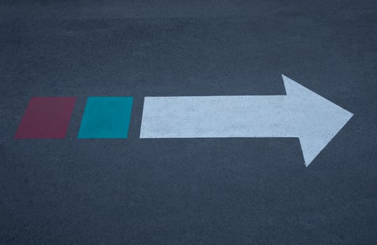 White arrow sign with green and red on the end. photo