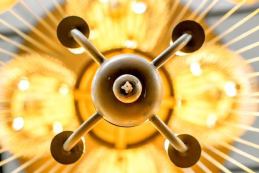 Look up view of modern chandelier in  hotel lobby. photo