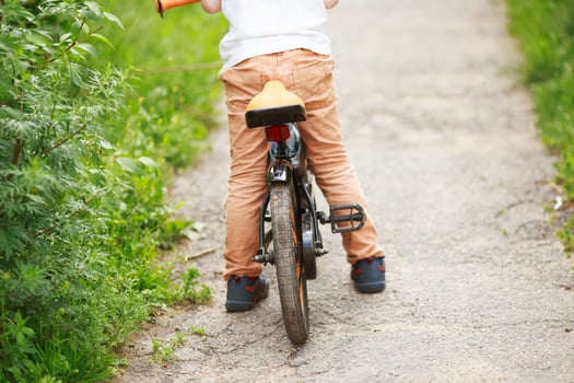 Boy with a bicycle on the street photo