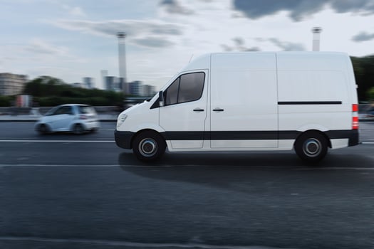 Transportation service with a white van moving fast on the road photo