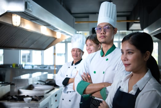 Portrait of a group of chefs and culinary students in the culinary Institute's kitchen. photo