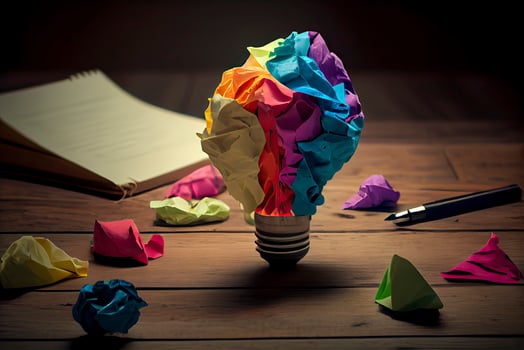 great idea concept with crumpled colorful paper and light bulb on wooden table photo