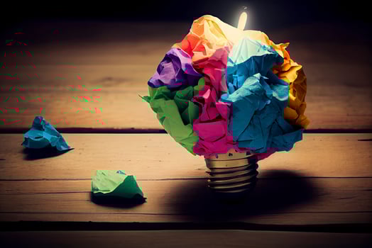 great idea concept with crumpled colorful paper and light bulb on wooden table photo