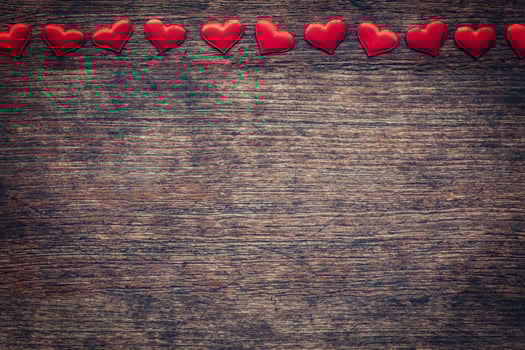 Red heart on wood background with space for Valentine Day. photo