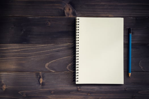 Office wood table with blank notepad, pencil. photo