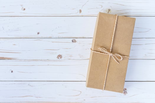 Top view above brown gift box on wooden background with space. photo