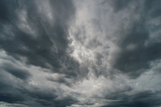 Dramatic thunder storm clouds at dark sky photo