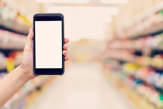 Hand woman holding and showing phone with blurred background in shopping mall. photo