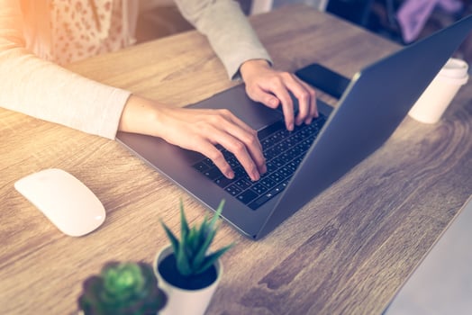 asian woman using laptop computer do online activity on wood table at home office. photo