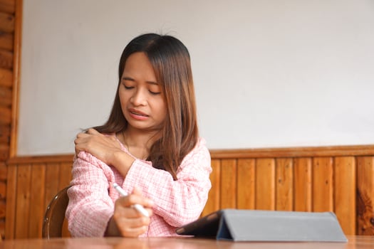 business woman has shoulder pain photo