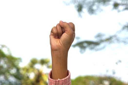woman raising her hands to the sky international women's day photo