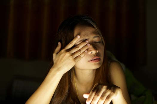 Asian women suffer from eyestrain from looking at computers in low light. watch movies online photo