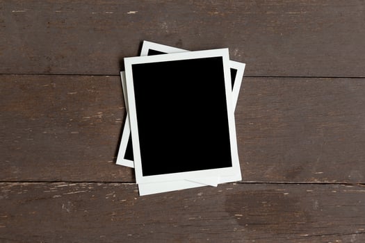 Photo frame on wood table background. Vintage concept.