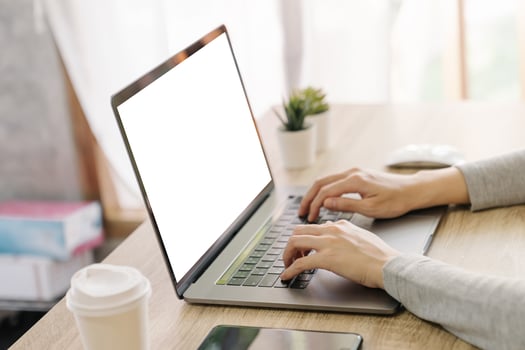 Business woman hand typing laptop computer on wooden table photo