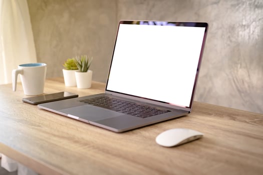 Laptop computer with blank screen on table. photo