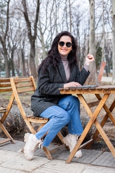 Beautiful businesswoman working on a laptop. Female freelancer connecting to internet via computer. Blogger or journalist writing new article. photo