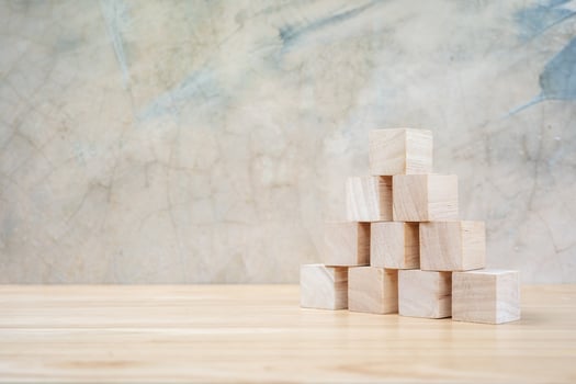 Wooden toy cubes on wooden table ang grey background photo