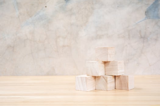Wooden toy cubes on wooden table ang grey background photo