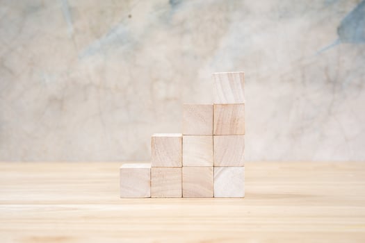 Wooden toy cubes on wooden table ang grey background photo