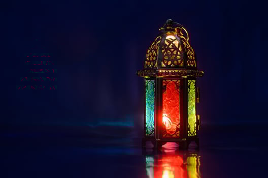 Lantern puts on table with dark blue background for the Muslim feast of the holy month of Ramadan Kareem. photo