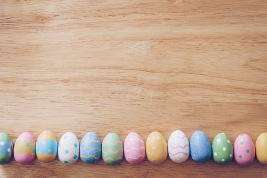 Colorful easter eggs on wooden table background vintage with copy space. photo