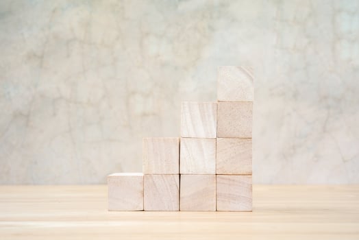 Wooden toy cubes on wooden table ang grey background photo
