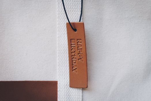 Close up Leather tag on bag with text Happy birthday photo